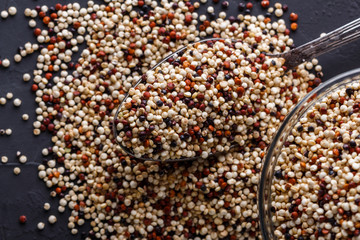 mix of quinoa grains on a dark stone background