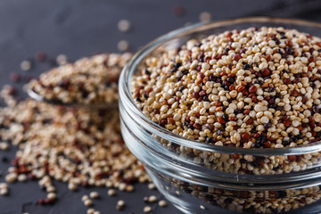 mix of quinoa grains on a dark stone background