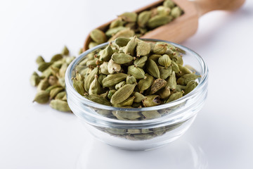 fragrant green cardamom on a white acrylic background