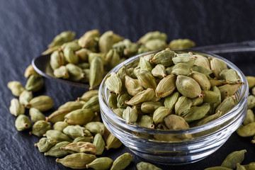 fragrant green cardamom on a dark stone background