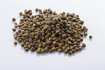 spicy green peppers on white acrylic background