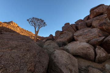 A beautiful arid mountain landscape at sunset, with fascinating rock formations in the foreground...