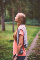 Fototapeta premium Beautiful young woman walks in the park