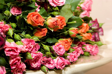 A large bouquet of orange and pink roses