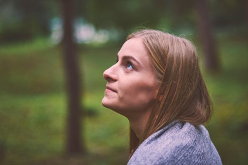 Beautiful young woman walks in the park