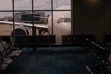 Empty rows of seat in waiting area inside international airport terminalю No passengers, tourists,...
