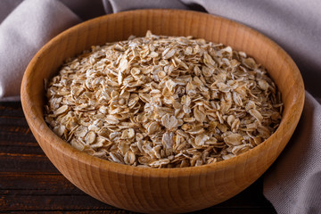 raw oatmeal on a wooden rustic background