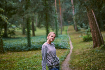 Beautiful young woman walks in the park