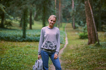 Beautiful young woman walks in the park