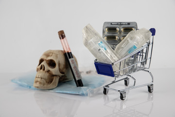 COVID-19 blood sample tube, new coronavirus 2019 - 2020. Blue tablet and medical mask on the table