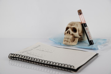 COVID-19 blood sample tube, new coronavirus 2019 - 2020. Blue tablet and medical mask on the table