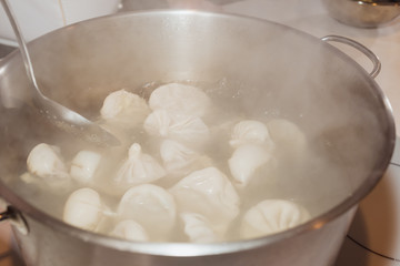 Traditional homemade manti is cooked in the kitchen. Close-up.