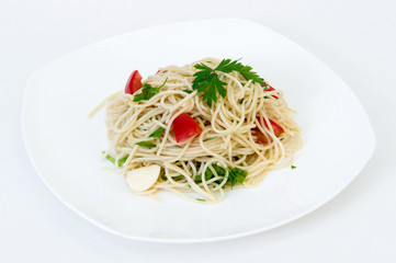 Pasta with vegetables on a plate on a white background