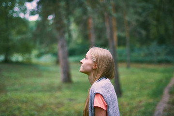 Beautiful young woman walks in the park