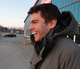 Obraz premium Millennial smiling outside of a icecream shop in winter