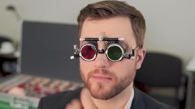 handsome man picks optics for eyepiece
