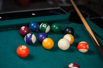 Billiards balls and cue on billiards table. Billiard sport concept