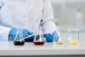 Fototapeta premium Scientist’s hands working with tablet in cbd laboratory