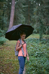 Beautiful young woman walks in the park