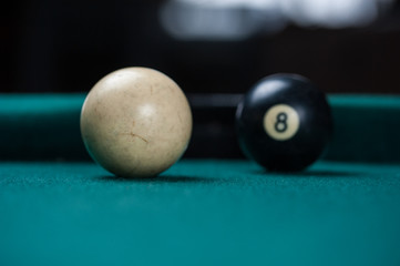 Billiards balls and cue on billiards table. Billiard sport concept