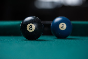 Billiards balls and cue on billiards table. Billiard sport concept
