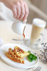 Fried Belgian waffles, dessert on the table in the restaurant in the style of Provence