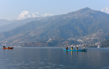 People moving on a canoe in the lake of Pokhara on Nepal