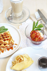 Delicious culinary dishes, desserts, ice cream, waffles and pancakes on the table in the restaurant in the style of Provence