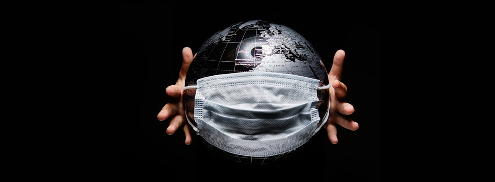 Kid holding globe map sphere isolated on black horizontal background. Ecological problems disasters. COVID-19 pandemic infection disease concept image, copy space for text
