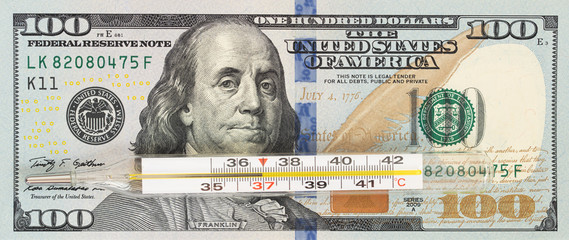 100 dollar bill and thermometer