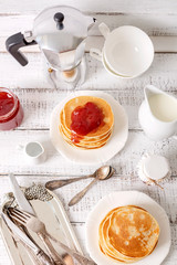Tasty breakfast. Pancakes with strawberry confiture and butter.