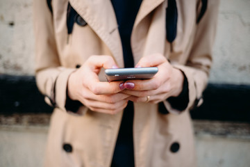 Young woman wearing beige coat