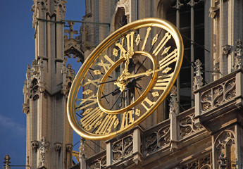 Fototapeta na wymiar Antwerp, Belgium. Golden turret clock of Cathedral of Our Lady