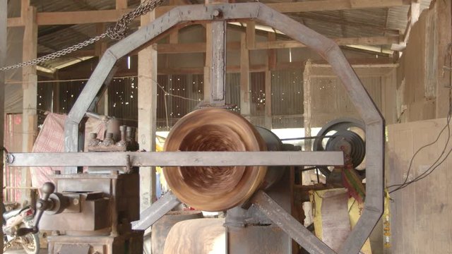 Workers forming long drum By using a rotating motor and using sharp object for forming
