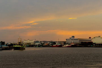 Fishing boats moored at the docks with beautiful sky