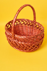 Brown basket in yellow background