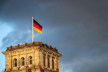 Fototapeta na wymiar German flag waving outdoor above governmental building of Reichstag, Berlin, Germany