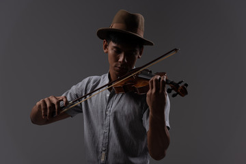 Handsome asian man hold violin in arm,practice and play music before concert, in emotion feeling...