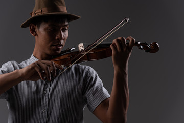 Handsome asian man hold violin in arm practice and play music before concert, in emotion feeling committed.