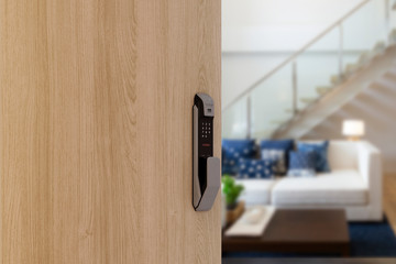 Digital Door handle or Electronics knob  for access to room security, Door wooden half opening through interior living room background, selective focus