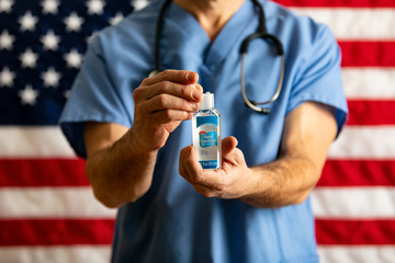 Health: Male Doctor Opens Small Bottle Of Hand Sanitizer To Kill Virus