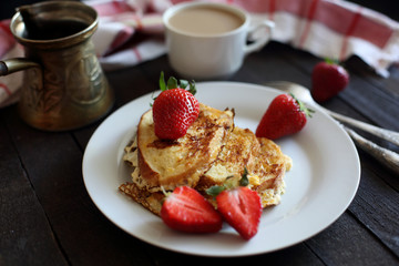 toast fried with egg with strawberries and coffee for Breakfast
