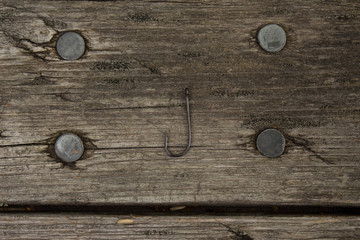 fishing hook on wooden background