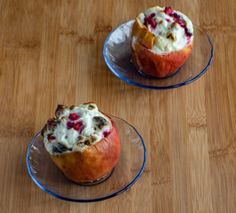 Baked  apples with cottage cheese and berries   on wooden table, high resolution photo