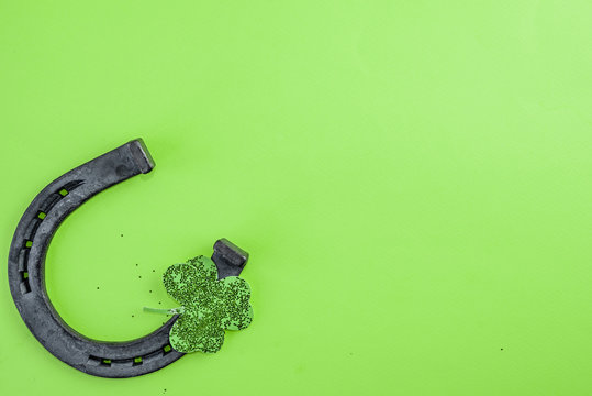 St. Patrick's Day concept. Old horseshoe and clover leaf - Powered by Adobe
