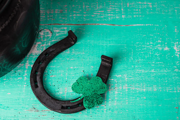 St. Patrick's Day concept. Old horseshoe and clover leaf