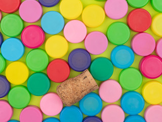Lot of colorful plastic lids and a wooden tube.