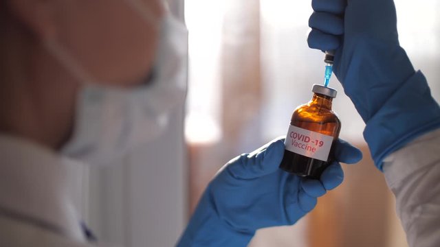 Medical doctor or laborant holding tube with nCoV Coronavirus vaccine for 2019-nCoV COVID virus. Novel Coronavirus originating in Wuhan, China. Coronavirus 2019-nCoV COVID concept.