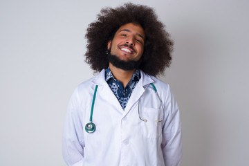 Horizontal portrait of pleasant-looking African doctor female wearing medical uniform covering her...