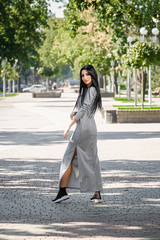 Fototapeta premium Attractive brunette in dress outdoors in spring